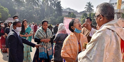 Christian devotees receive communions on the occasion of Christmas outside the Don Bosco Church in Guwahati. (Photo | PTI)