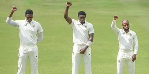 From left) South Africa's Lungi Ngidi, Lutho Sipamla and Temba Bavuma raise their fists in solidarity against apartheid during the first Test against Sri Lanka. (Photo| AFP)
