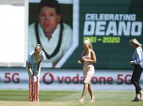Daughters of former Australian cricketer Dean Jones, Phoebe, left, and Augusta walk with their mother, Jane, right, for a tribute for the late batsman who died in India. (Photo | AP)