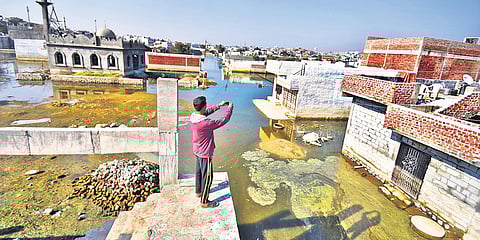 A resident takes an aerial photo of the stagnant water in Osman Nagar, on the outskirts of Hyderabad. (Photo | S Senbagapandiyan, EPS)