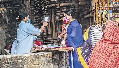 Family members of sevayats being screened at the temple’s gate in Bhubaneswar on Sunday | Express