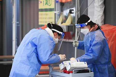 Medical workers wearing protective gear prepare for a coronavirus test at a coronavirus testing site in Seoul, South Korea. (Photo | AP)