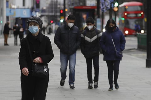 Pedestrians wear masks as they walk on Oxford Street in London, Saturday, Dec. 26, 2020. (Photo | AP)