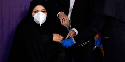 A woman is injected with the Coviran coronavirus vaccine produced by Shifa Pharmed, part of a state-owned pharmaceutical conglomerate, in a ceremony in Tehran. (Photo| AP)