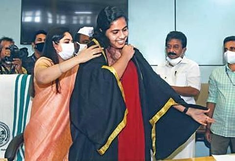 District Collector Navjyot Khosa drapes the ceremonialrobe of the Thiruvananthapuram mayor on Arya Rajendran after the swearing-in ceremony on Monday. Arya is the youngest mayor in India| BP DEEPU