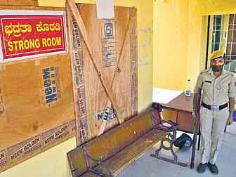 A policewoman stands guard at a strongroom at Nelamangala Junior College, where ballot boxes have been stored, in Bengaluru on Monday | Shriram BN