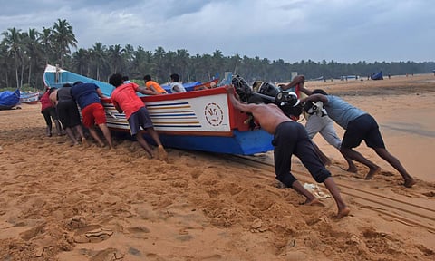 Fishermen at Poonthura coast in Thiruvananthapuram shift their boats to a safe zone. (Photo | B P Deepu, EPS)