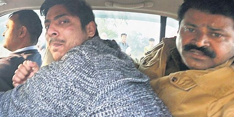 File photo of police taking away Kapil Gujjar after he opened fire at Shaheen Bagh area of Delhi (Photo | Shekhar Yadav, EPS)