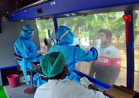People give their swab samples for Covid-19 test at Sanjeevini bus at the ENT hospital in Visakhapatnam on Tuesday. (Photo | EPS/G Satyanarayana)