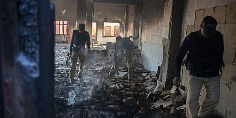 Policemen inspect the burnt Hindu temple a day after a mob attack in a village in Karak district near Peshawar. (Photo| AFP)