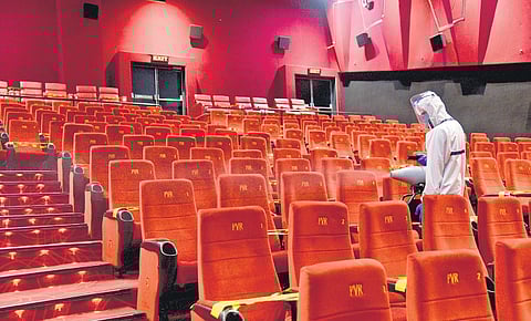 Sanitation workers cleaning out a theatre.