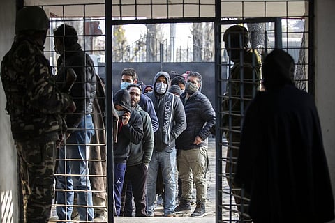 Kashmiris wait in a queue to cast their votes during the first phase of District Development Councils election on the outskirts of Srinagar. (Photo | AP)