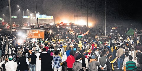 Protesters block a part of the Delhi-Meerut National Highway near Ghazipur against the new farm laws on Thursday. (Photo | PTI)
