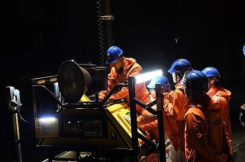 Rescuers adjust an emergency generator at the Diaoshuidong coal mine in southwestern China's Chongqing. (Photo | AFP)
