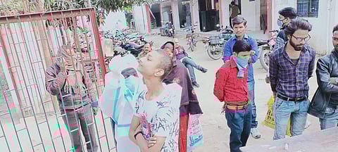 People caught without masks wait for a COVID test at a police station in Sitamarhi (Photo | Express)