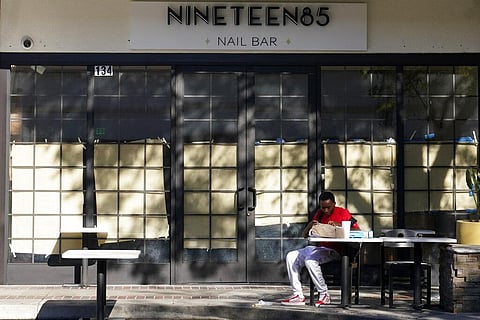 A lone patron eats outside of a row of closed-off shops and restaurants Friday, Dec. 4, 2020, in Burbank, Calif. (Photo | AP)