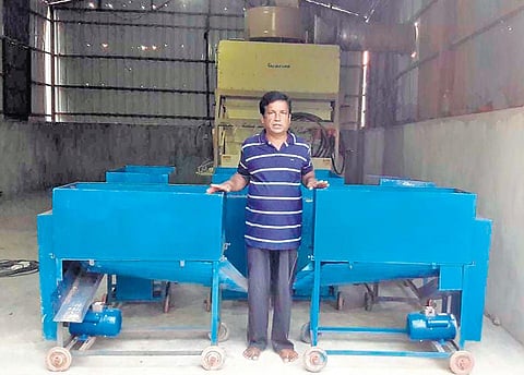 Dilip Baral with his deseeding machine in Resinga village of Puri district. (Photo | EPS)