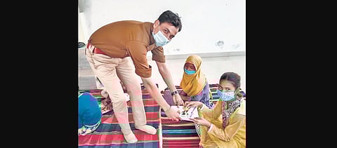 GRP constable Rohit Kumar Yadav distributes study material to children of his school in Unnao