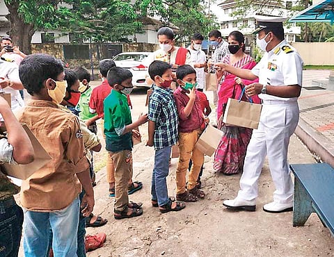 Commodore Anil Joseph, Commanding Officer, INS Venduruthy, and wife Jenny Susan Joseph give gifts to the children of orphanages as a goodwill gesture from the Navy on the occasion of Navy Week celebra