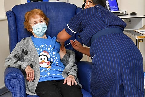 90 year old Margaret Keenan, the first patient in the UK to receive the Pfizer-BioNTech COVID-19 vaccine, administered by nurse May Parsons. (Photo | AP)