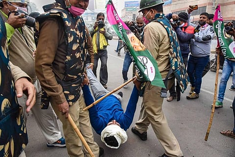 Police detain Jan Adhikar Party activists during a protest in support of the nationwide strike called by agitating farmers. (Photo | PTI)