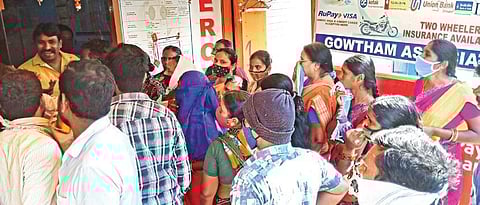 Flood victims queue up in front of a Meeseva centre for Rs 10,000 relief, at Prasanth Nagar Colonyin Hyderabad on Monday | Vinay Madapu