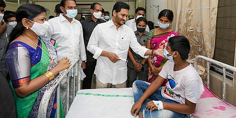Andhra Pradesh CM Y S Jagan Mohan Reddy meets patients who fell ill suspectedly due to water contamination at a hospital in Eluru town Godavari district Monday. (Photo | PTI)