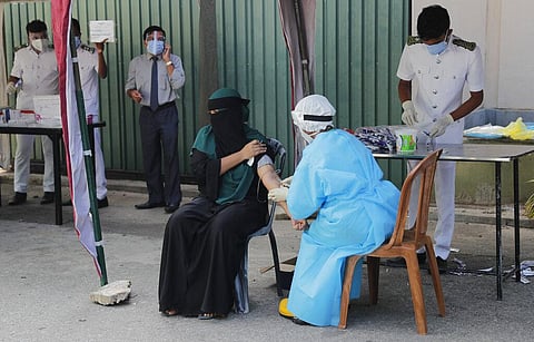 A Sri Lankan health official takes a blood sample from a woman to test for antibodies for COVID-19 in Colombo, Sri Lanka. (Photo | AP)