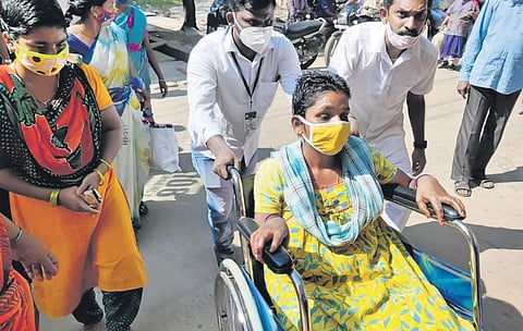 A woman with symptoms of unknown illness, being brought to the Government General Hospital in Eluru on Tuesday. (Photo | EPS)