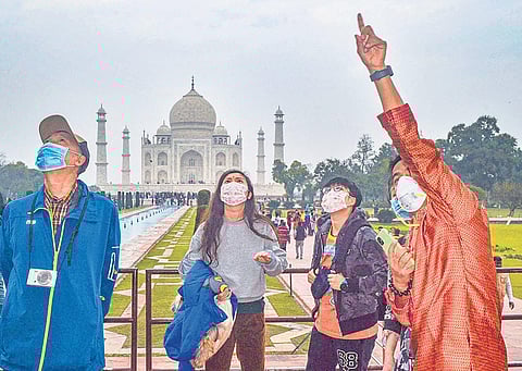 Tourists wear protective face masks at Taj Mahal in Agra