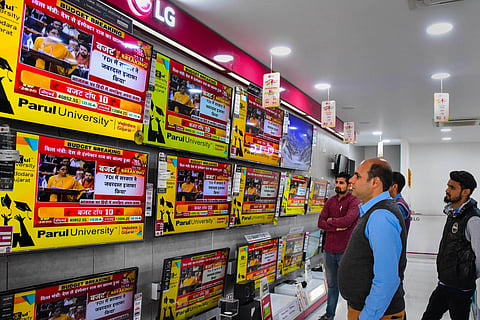 Employees at a showroom watch on TV sets Finance Minister Nirmala Sitharaman tabling the Union Budget 2020-21 in the Lok Sabha in Bikaner Saturday Feb. 1 2020. (Photo | PTI)