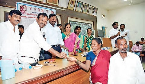 Devarakadra MLA Ala Venkateshwar Reddy along with Mahabubnagar district collector D Ronald Rose hand out tokens to the beneficiaries of the double bedroom housing scheme