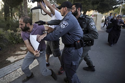 Israeli police push a man during a protest outside a hospital in Jerusalem where Samir Arbeed, a Palestinian suspect in a deadly West Bank bombing, is being treated. (Photo | AP)