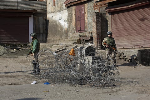 Indian paramilitary soldiers stand guard near a barbed wire set up as road blockade during a strike in Srinagar, Sunday, Feb. 9, 2020. (Photo | AP)