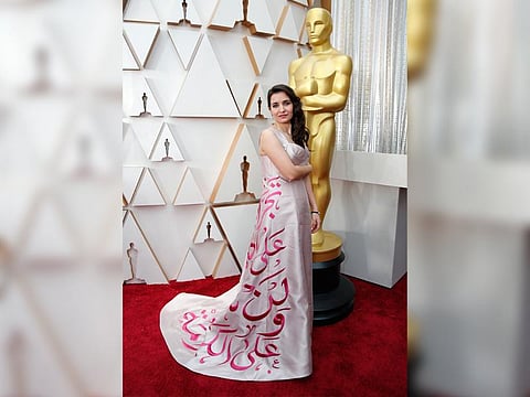 Waad al-Kateab, co-director of the documentary “For Sama,” used her gown for some political messaging in Arabic. (Photo | AP)
