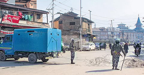 Security personnel patrol a road in Srinagar during the strike on Sunday. Internet was also temporarily suspended. (Photo | PTI)