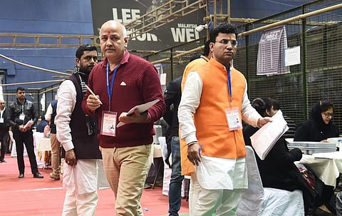 Deputy chief minister Manish Sisodia and BJP Candidate Raviender Singh Negi (right) at a counting station in New Delhi. (Photo | Parveen Negi, EPS)