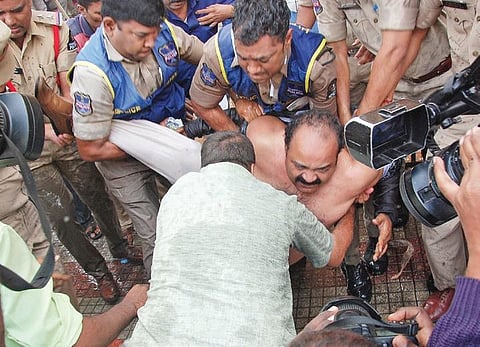 Police stopping Dr Vasanth from immolating himself at Gandhi Hospital in Hyderabad on Tuesday.