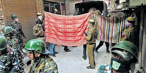 Police personnel stand outside a house where five members of a family were found dead in Bhajanpura area of New Delhi on Wednesday. (Photo | EPS)