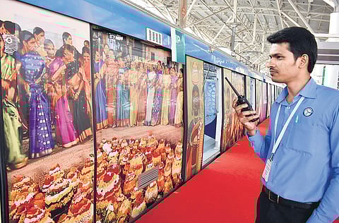An HMRL employee stands next to a Metro train that display images of the State’s heritage | S Senbagapandiyan