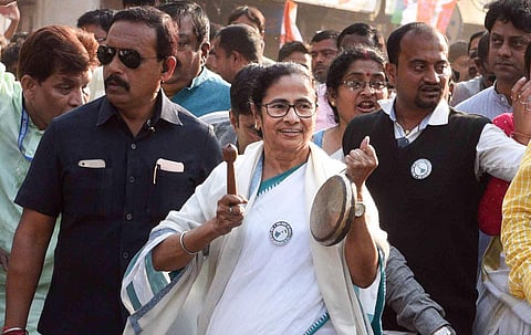 West Bengal CM Mamata Banerjee plays a musical instrument as she leads a rally to protest against CAA, NRC and NPR at Durgapur. (File photo| PTI)