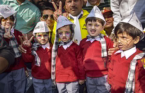 Children dressed as AAP convenor Arvind Kejriwal arrive at the Ramlila Maidan for his swearing-in ceremony in New Delhi. (photo| PTI)