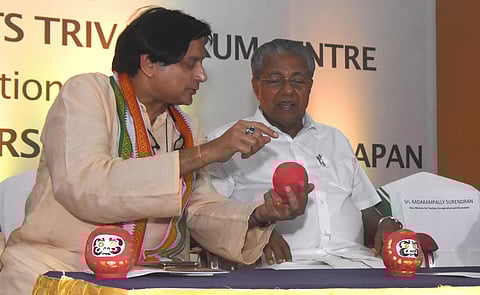 Shashi Tharoor, MP, describing the Daruma doll, a traditional handmade Japanese wishing doll, to Chief Minister Pinarayi Vijayan during the inaugural session of ‘Discover Japan’ festival in Thiruvananthapuram on Friday. (Photo |B P Deepu, EPS)