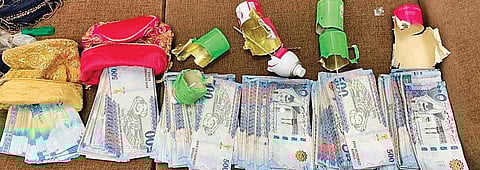 A physical checking revealed currency notes concealed under the false back of the backpack.