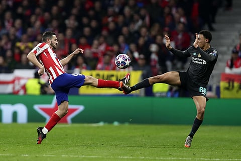 Atletico Madrid's Koke, left, and Liverpool's Trent Alexander-Arnold fight for the ball during their Champions League clash. (Photo | AP)