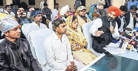 Delhi Sikh Gurdwara Management Committee president Manjinder Singh Sirsa with 10 Hindu families who have arrived from Pakistan seeking refuge. (Photo | PTI)