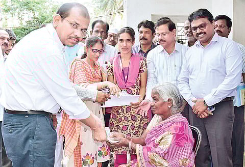 Principal Secretary of Panchayat Raj and Rural Development Gopal Krishna Dwivedi handing over pension to a woman at Ibrahimpatnam on Saturday | Express