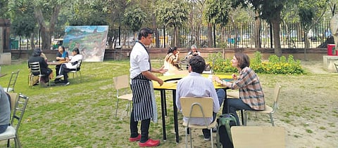 Somi Chatterjee of OSMS talking to visitors and a recreation of Harappan era kitchen.