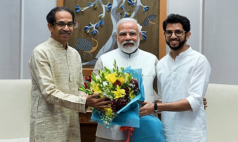 Maharashtra CM Uddhav Thackeray and state tourism minister Aaditya Thackeray with PM Narendra Modi in New Delhi on Friday (Photo | Twitter)