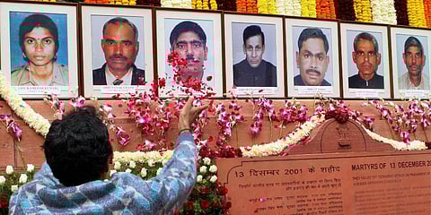 A Parliament staff pays tribute to the staffers and security personnel, sacrificed their lives in 2001 terrorist attack, at the Parliament House in New Delhi. (Photo | PTI)